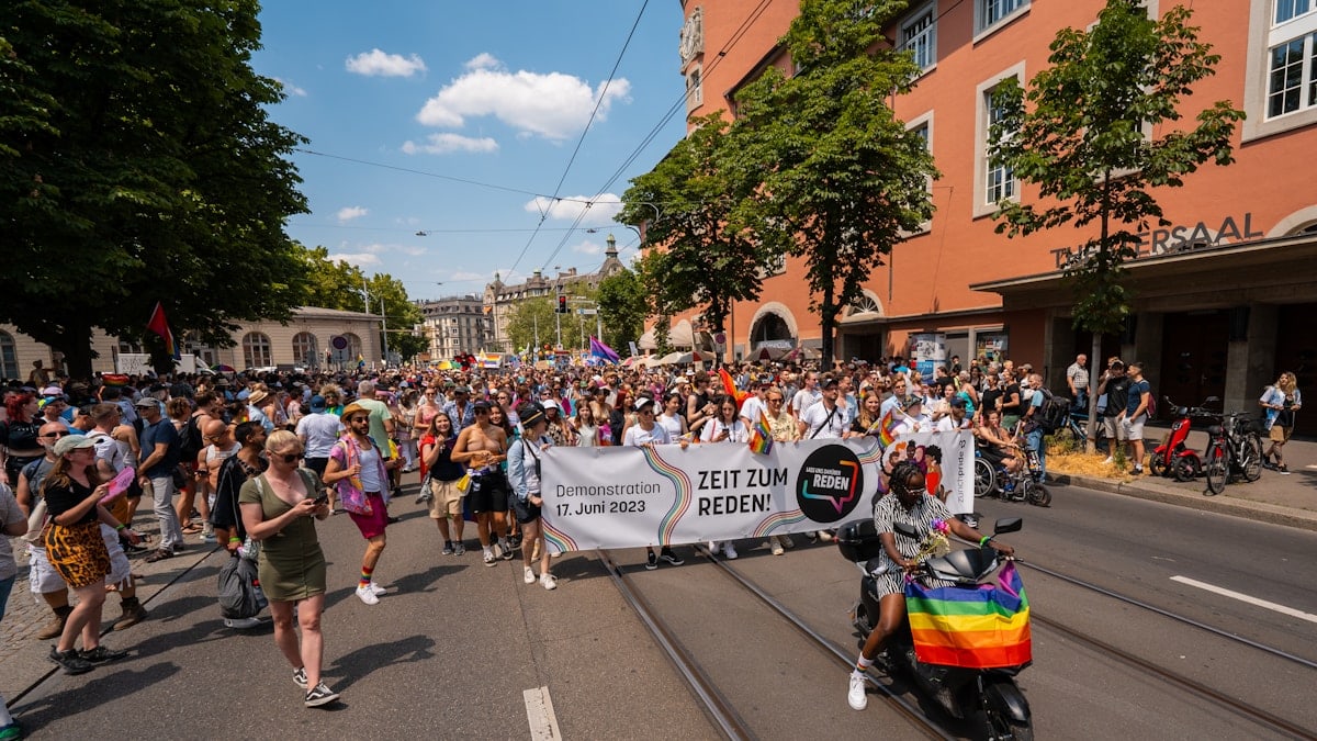 a large group of people walking down a street